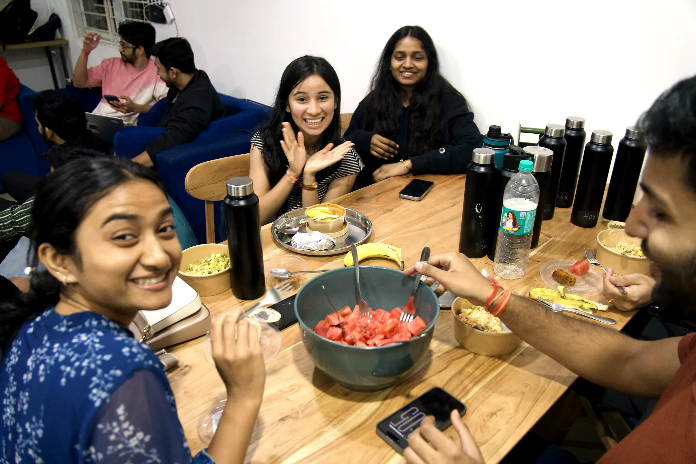 Founders sharing a laugh around the dining table in the Residency house