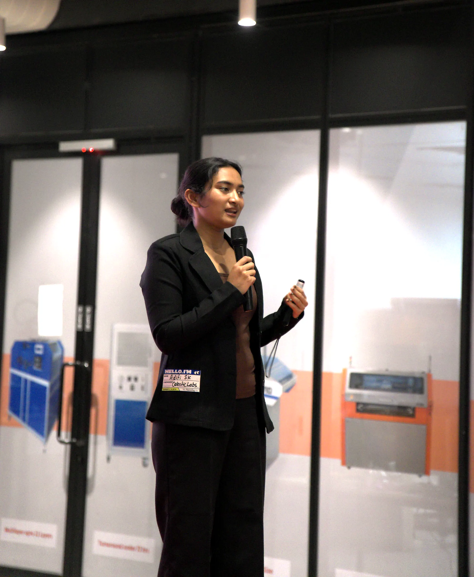 A founder speaking into a microphone during her pitch
